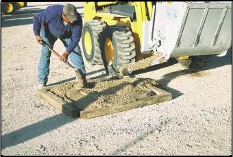 Scoop-N-Mix mixer pouring cement from side chute